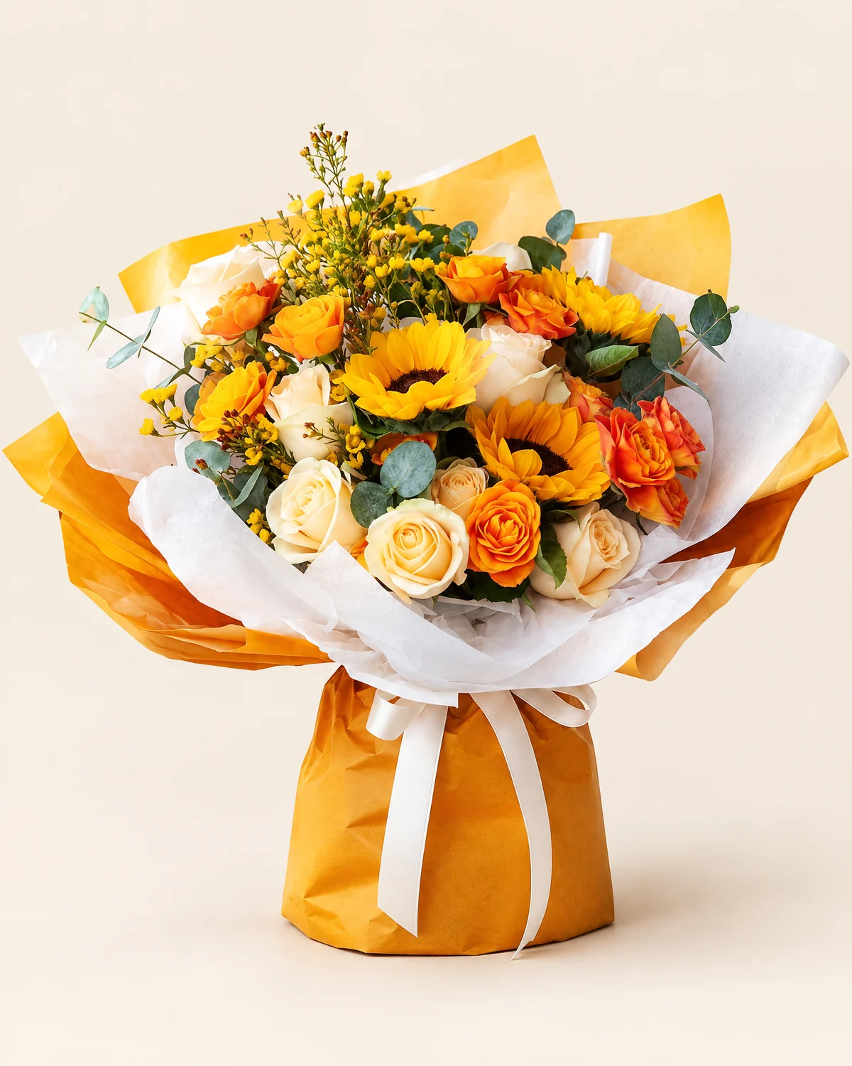 Warm Sun Tribute Bouquet — Sunflowers — 3 stems, Champagne roses — 9 stems, Orange multi-head roses — 5 stems (6–8 heads per stem), Yellow or orange waxflower, 5 stems, Large-leaf eucalyptus — 5 stems