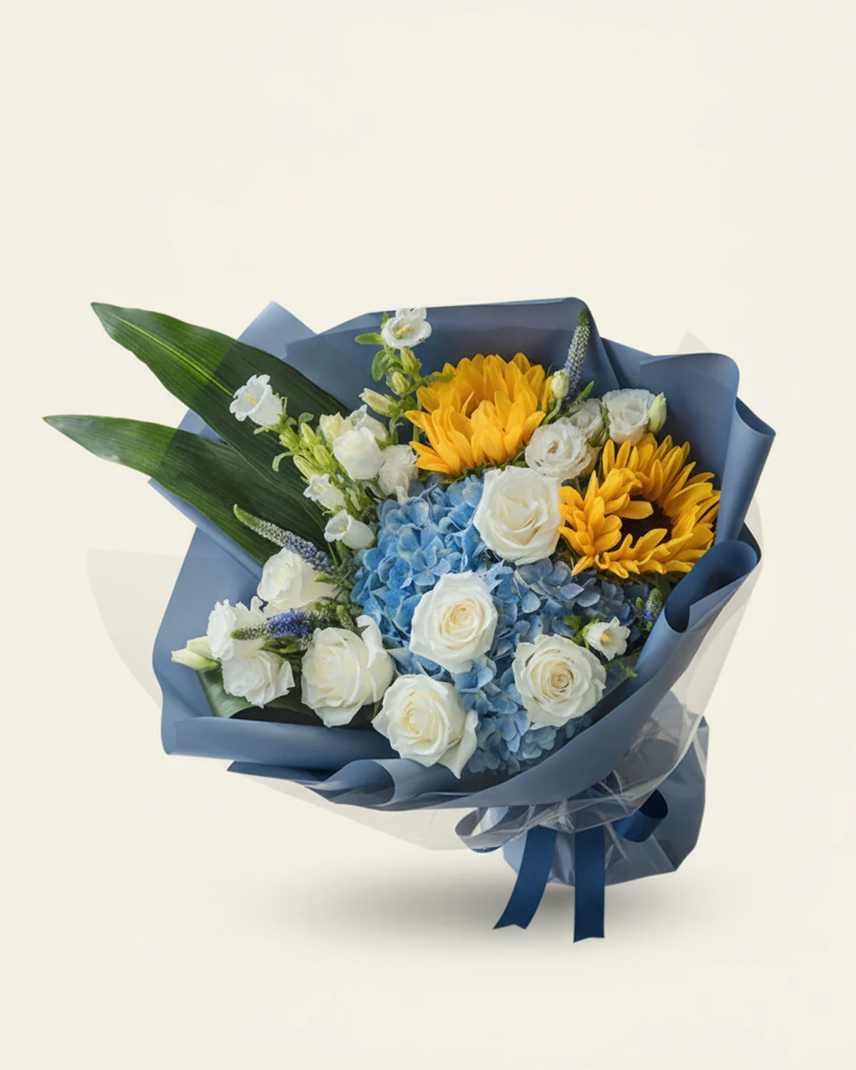 Quiet Devotion Bouquet — White roses — 5 stems, Blue hydrangea — 1 stem, Sunflowers — 2 stems, White lisianthus — 5 stems (3+ heads per stem), Purple salvia, 5 stems, White campanula, 4 stems, Aspidistra leaves — 3 stems