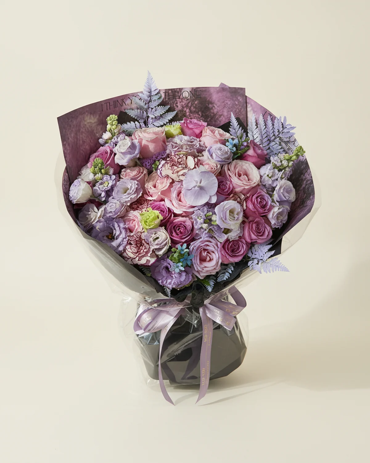 Violet Reverie for Dad — 10 purple roses, 9 pink roses, 4 white eustoma (3+ heads per stem, sprayed purple), 3 purple ruffled eustoma (3+ heads per stem), 1 white phalaenopsis orchid (sprayed purple), 4 'Purple Elf' carnations, 2 blue star flowers, 4 purple stock flowers, 4 alpine fern fronds (sprayed purple)