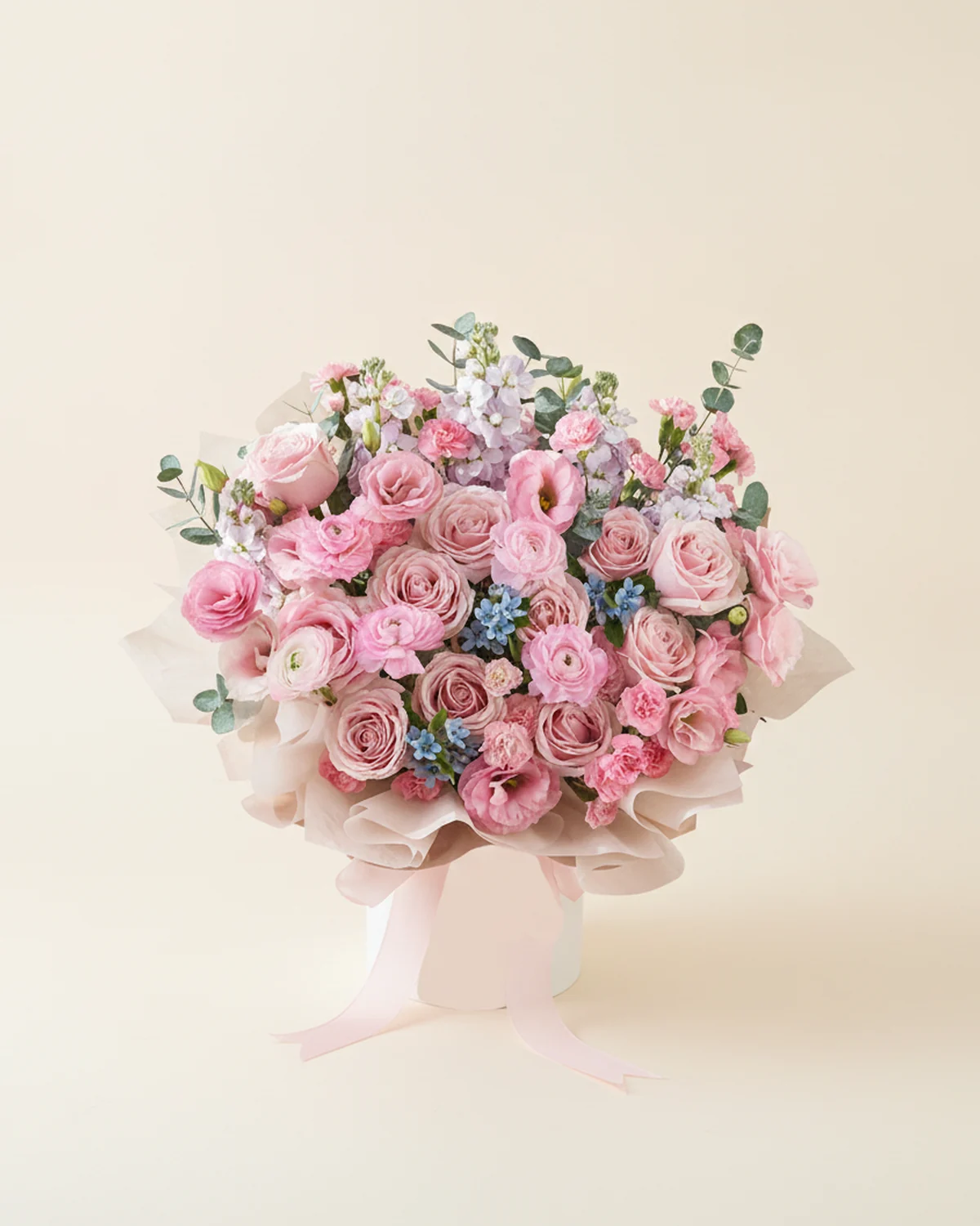 A Gentle Embrace for Dad — 11 pink roses, 5 light purple stock flowers, 3 blue star flowers, Pink ranunculus, 5 stems, 6 light pink eustoma stems (3+ heads per stem), 8 pink multi-headed carnation stems (4+ heads per stem), 15 large-leaf eucalyptus stems