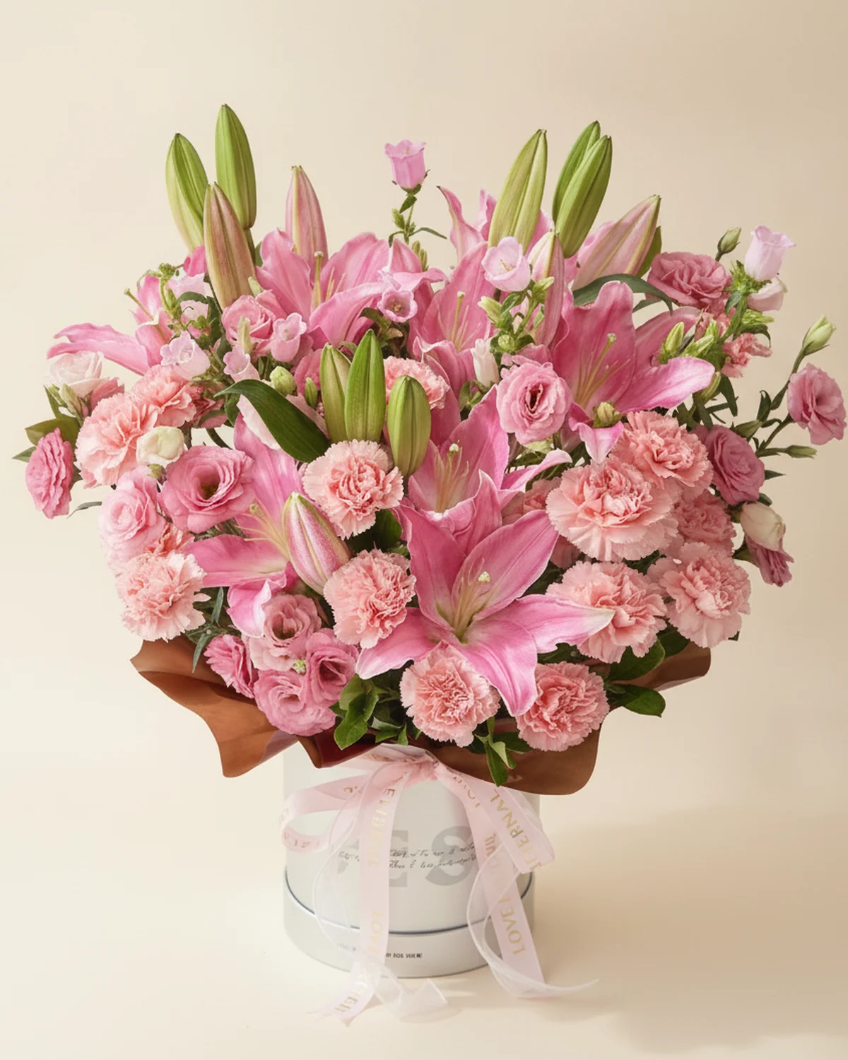 Father's Constant Companion — Pink Embrace Bucket Bouquet — 3 pink lilies (5+ heads per stem), 20 pink carnations, 5 pink lisianthus stems (3+ heads per stem), 5 pink bellflower (campanula) stems, Gardenia foliage, one large 19.5 cm embrace bucket