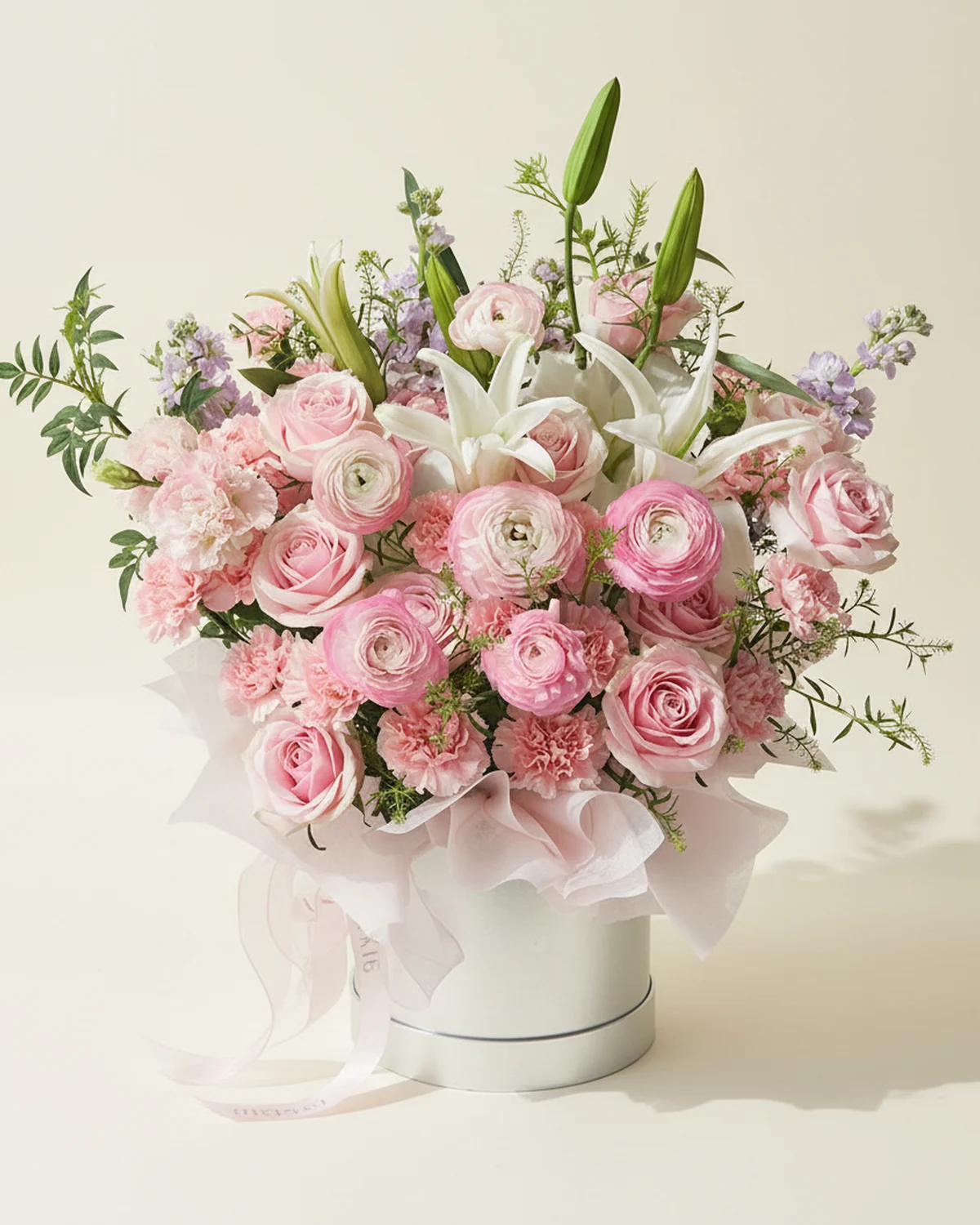 Gentle Tribute for Dad — Pink Mixed Bouquet — 18 pink carnations, 4 light-purple stock flowers, 2 white lilies (3+ heads per stem), Pink ranunculus, 5 stems, 11 pink 'Snow Mountain' roses (or 'Luoshen' roses), 1 pink ruffled lisianthus stem (3+ heads per stem), Green Trick dianthus, one large 19.5 cm embrace bucket