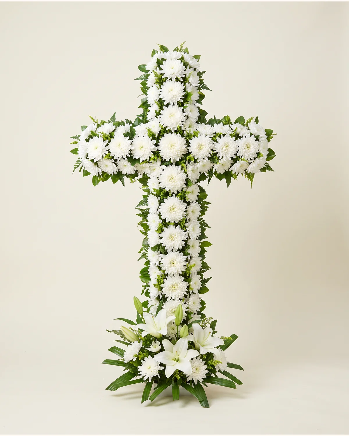 White Floral Sympathy Cross — white fresh flowers, green foliage cross base, upright display