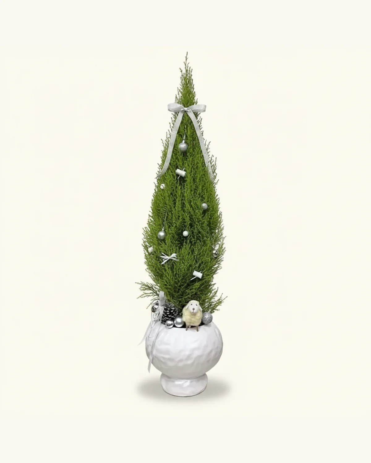 110cm Silver and White Decorated Christmas Tree — Goldcrest Cypress Christmas tree, White ceramic pot, Silver ribbon bow, Silver baubles, White ornaments, Sheep figurine, Pine cone
