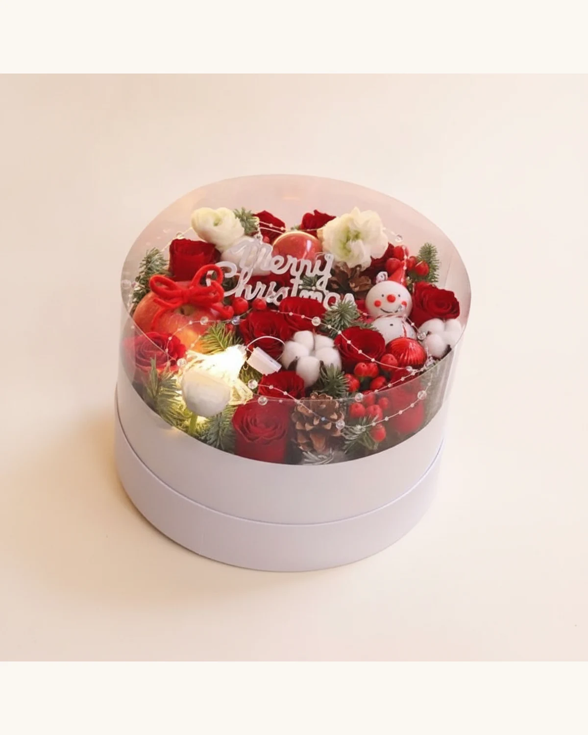 Christmas Red Rose & Snowman Gift Box — Red Roses, White Eustoma, Cotton Flowers, Apple, Pine Cones, Ilex, Pine Leaves, Snowman Ornament, Merry Christmas Topper, LED String Lights, Round Transparent Gift Box
