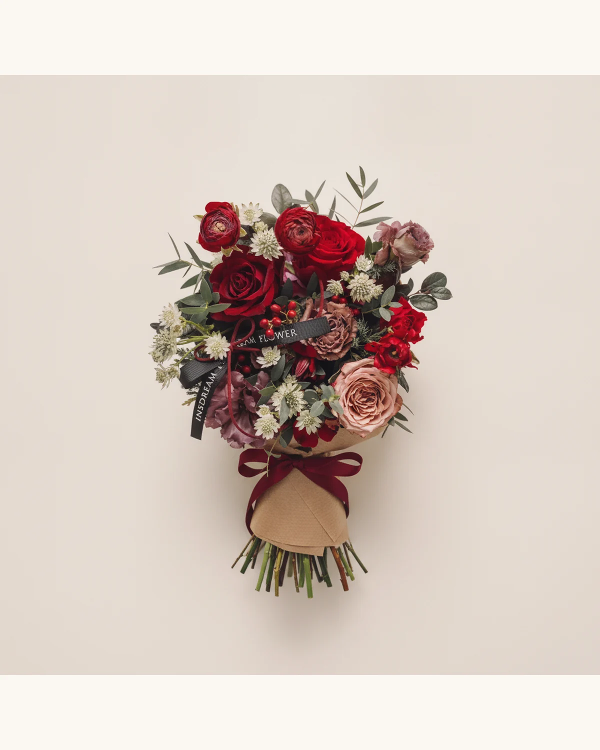 Red Rose and Ranunculus Christmas Bouquet — Red Rose, Cappuccino Rose, Ranunculus, Astrantia, Holly Berries, Eucalyptus, Kraft Paper Wrapping